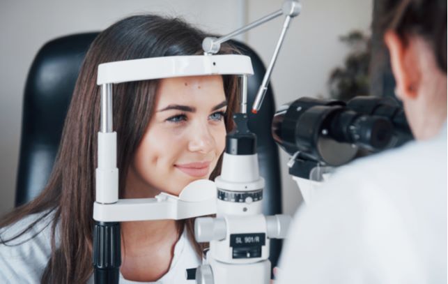 Young women undergoing eye exam at eye doctors office
