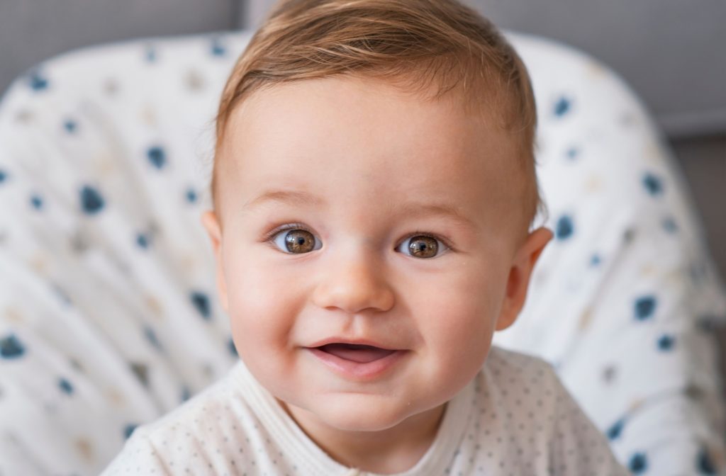 A happy, smiling baby with big bright eyes.