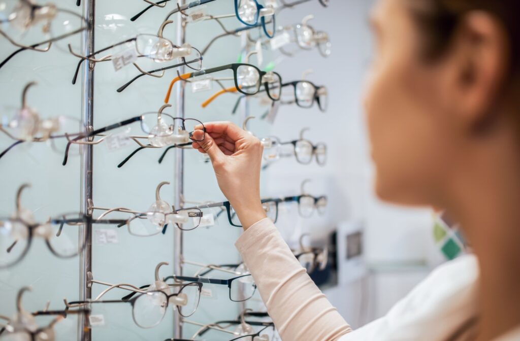 A person choosing a pair of eyeglasses from their local optometrist's office.